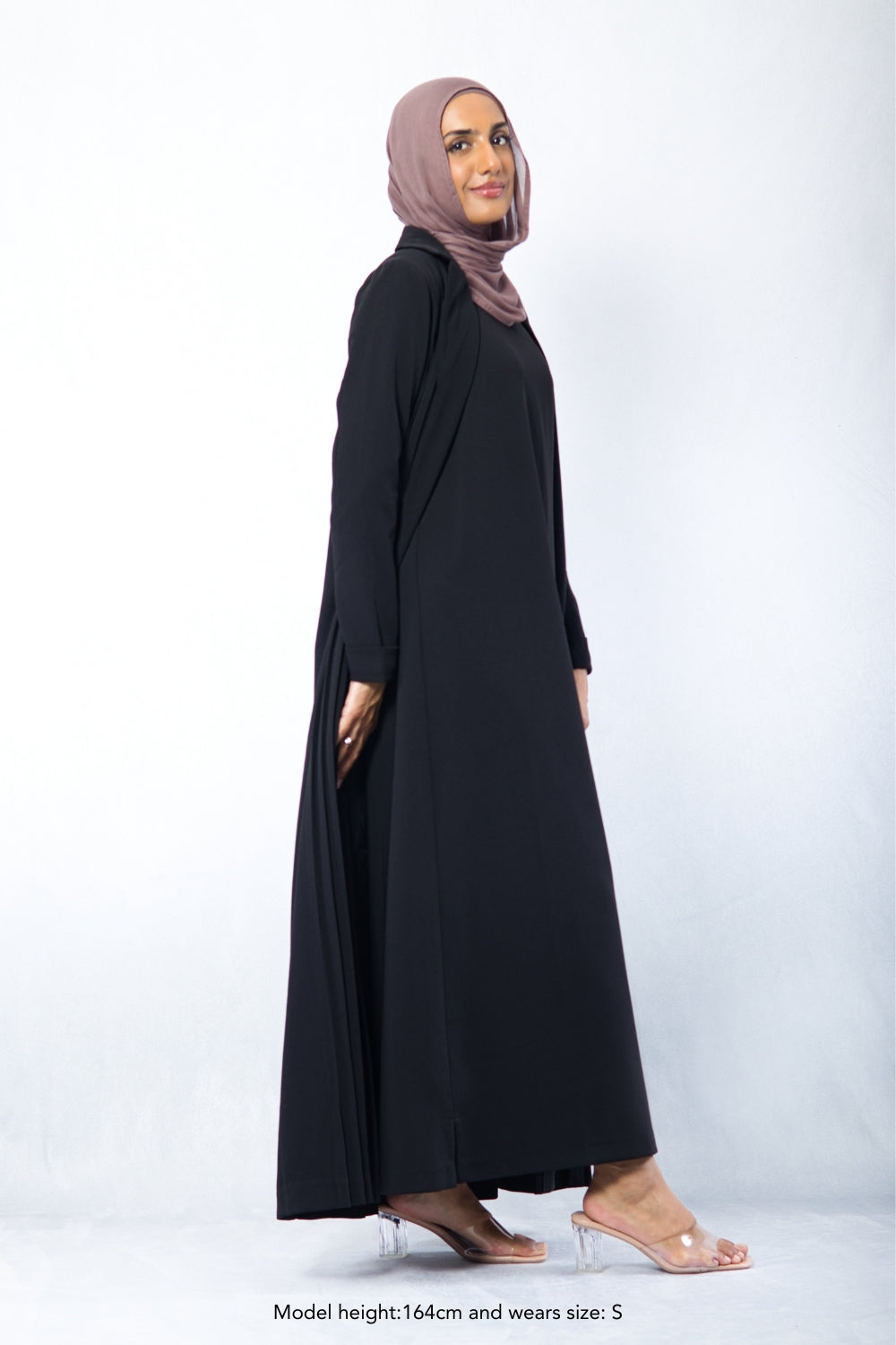 Side angle of black modest Amani Blazer Set showing loose fit and flowy pleated design, perfect for workwear
