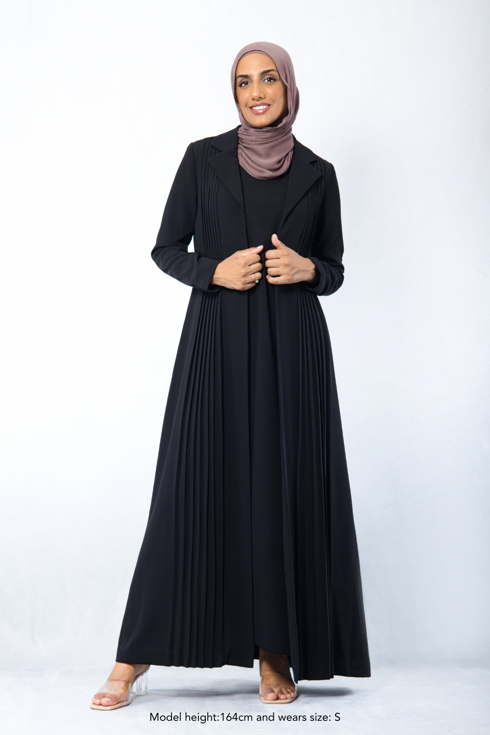 Modest black Amani Pleated Blazer Set with front pleats, styled for formal or corporate wear, worn by smiling hijabi model