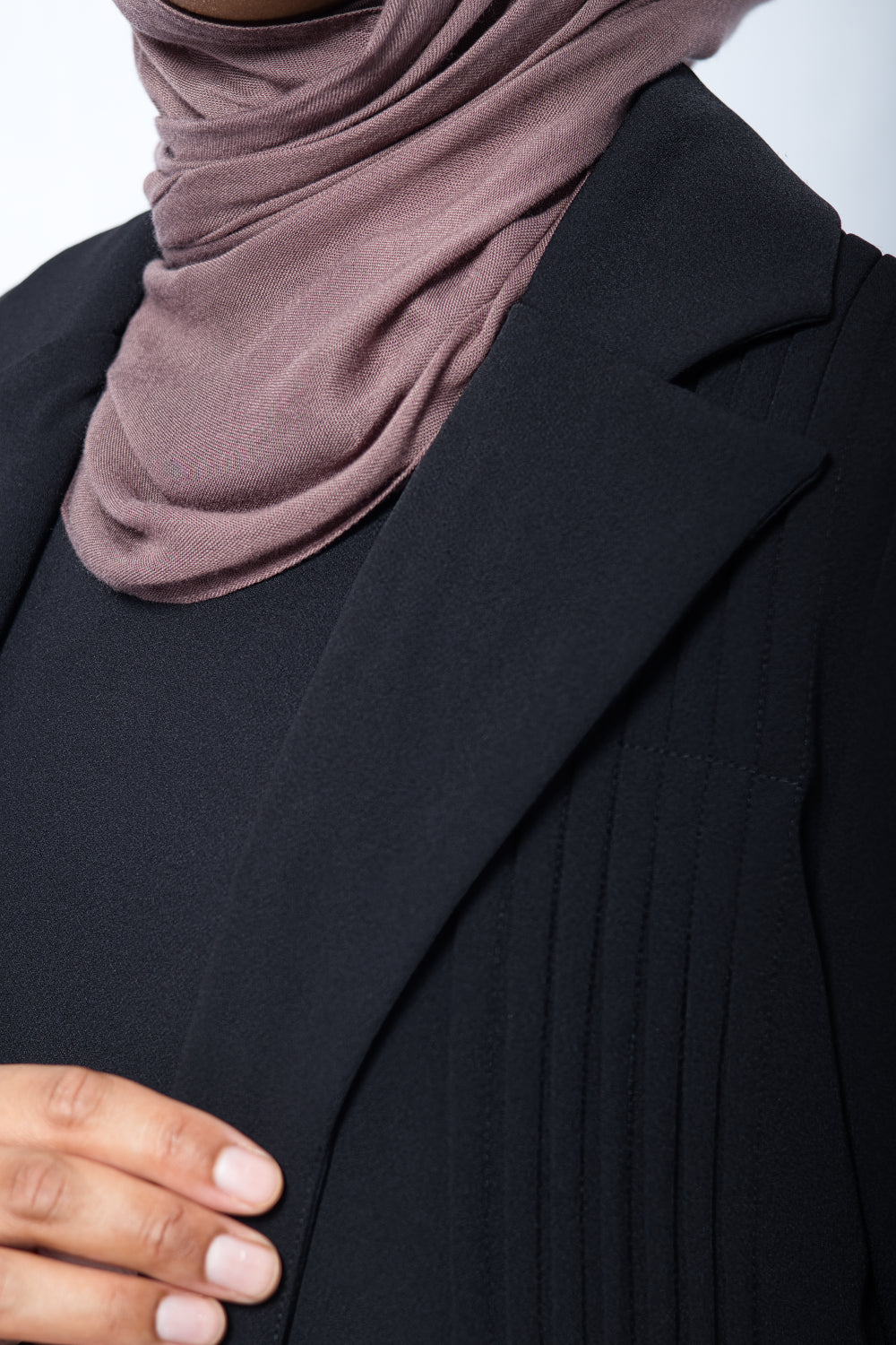 Close-up of pleated detailing and premium stitching on black Amani Blazer
